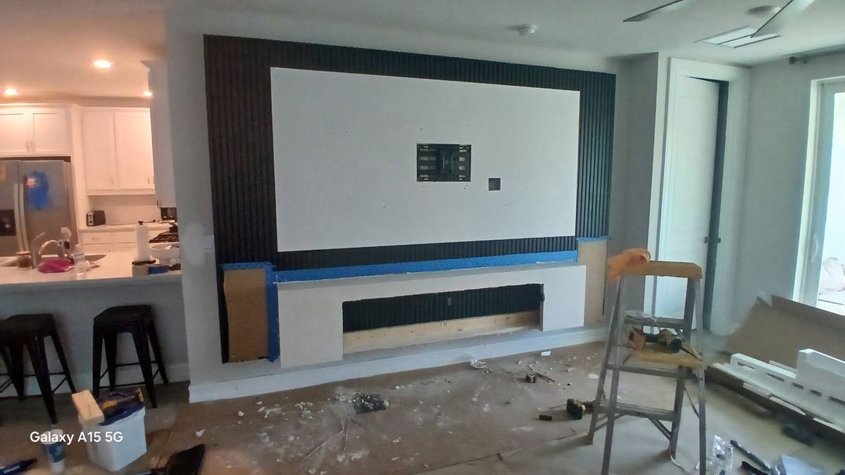 Entertainment wall during construction with fluted panels and fireplace framing Cape Coral FL