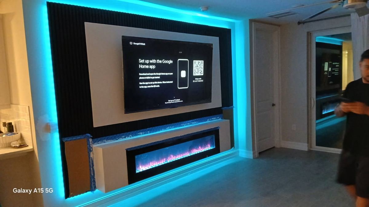 Completed custom TV and fireplace entertainment wall with LED backlighting Cape Coral FL