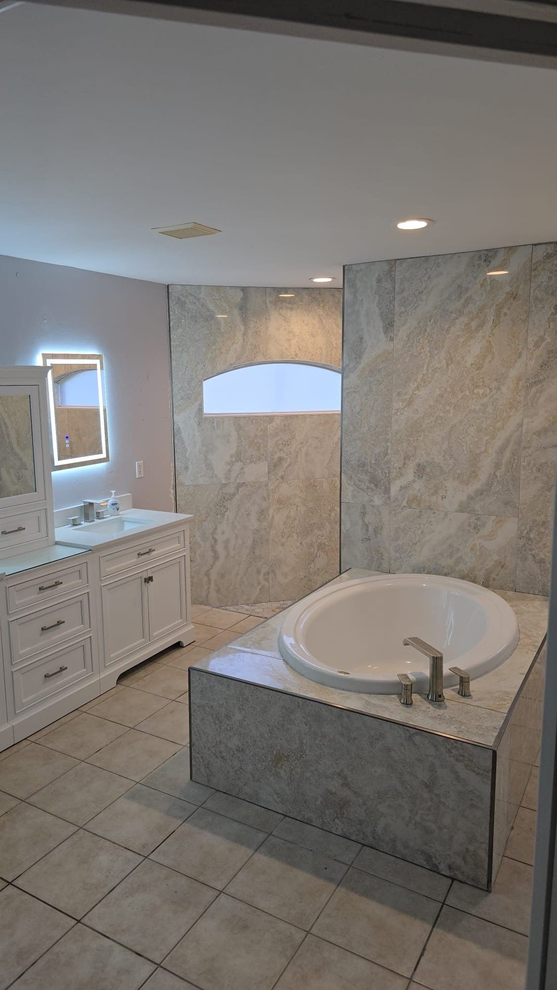 Completed bathroom tub surround with wood look tile and mosaic accent Fort Myers FL