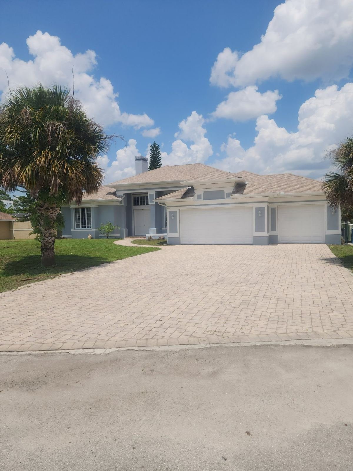 Completed exterior home paint job with modern gray color scheme Cape Coral FL